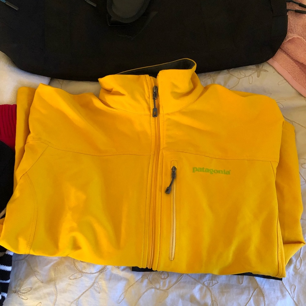 Men’s yellow Patagonia full zip shell.
